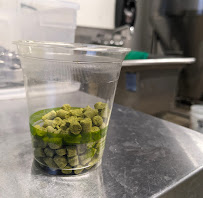 Green pellets in a plastic cup