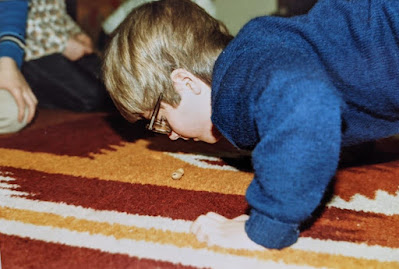 The winner of the peanut relay, pushing a peanut along that fantastic 70's carpet with his nose!