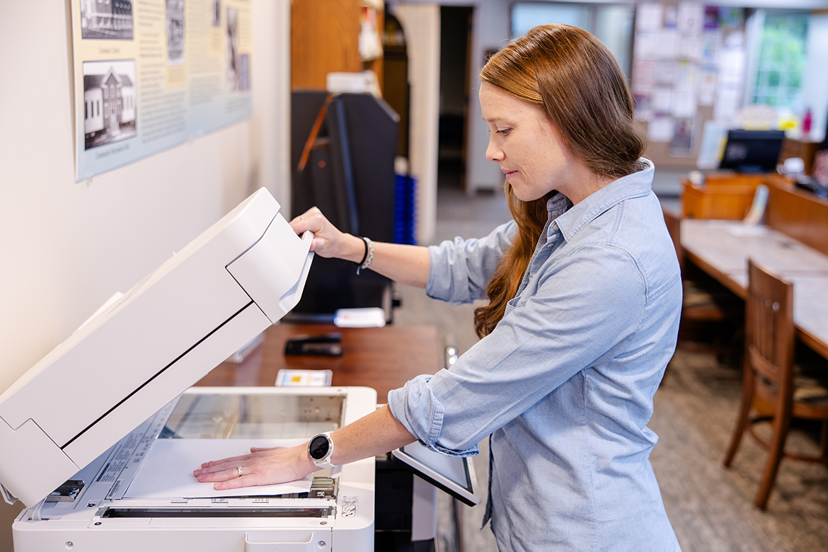 Woman using the in-house printer/scanner