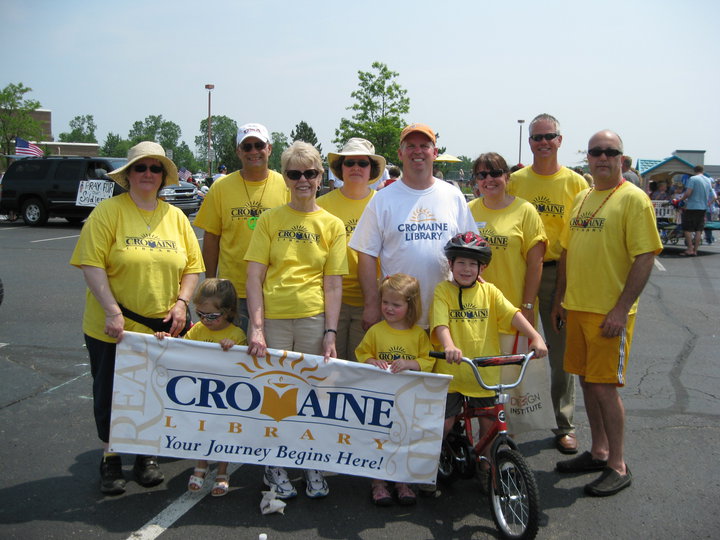 Cromaine staff, Board, and volunteers with a Library banner at the 2010 Memorial Day parade.