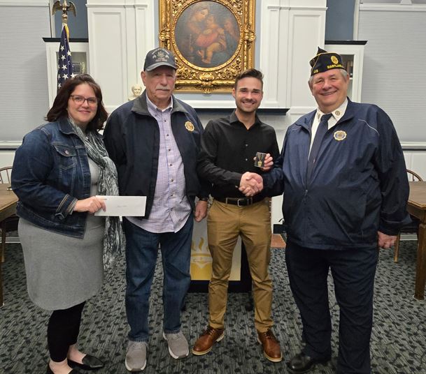 Gabriel Bliss with local veterans and Liz in the Community Room. 