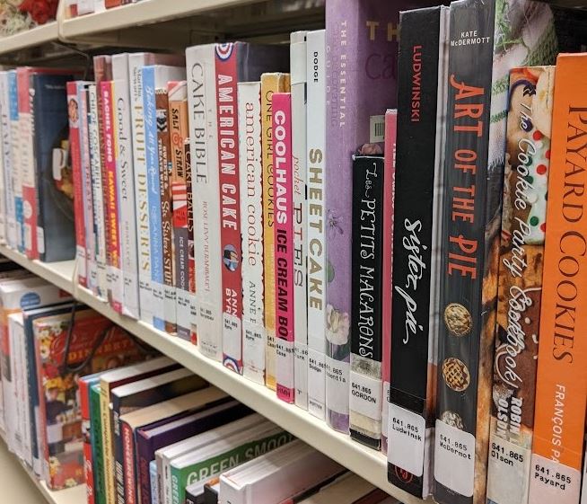 A variety of pie and dessert baking books on the shelf at Cromaine. 