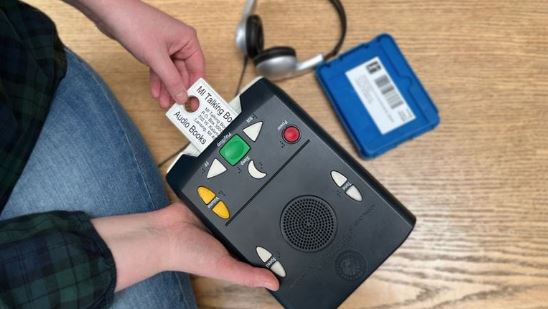 A patron using a talking book player. 