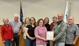 Hartland Township Trustees and Cromaine Library Leadership pose with Proclamation. Pictured left to right: Denise O'Connell, Trustee, Matthew Germane, Trustee, Summer McMullen, Trustee, Holly Naylor, President, Cromaine Library Board of Trustees, Sarah Neidert, Director, Cromaine Library, Kathie Horning, Treasurer, Larry Ciofu, Clerk, William Fountain, Supervisor, and Joseph Petrucci, Trustee.