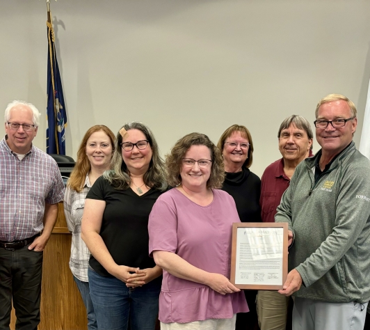 Hartland Township Trustees and Cromaine Library Leadership pose with Proclamation. Pictured left to right: Denise O'Connell, Trustee, Matthew Germane, Trustee, Summer McMullen, Trustee, Holly Naylor, President, Cromaine Library Board of Trustees, Sarah Neidert, Director, Cromaine Library, Kathie Horning, Treasurer, Larry Ciofu, Clerk, William Fountain, Supervisor, and Joseph Petrucci, Trustee.