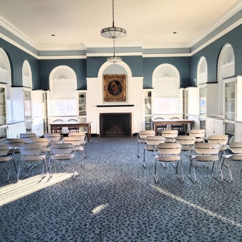 Room setup at the library with two desks and rows of chairs