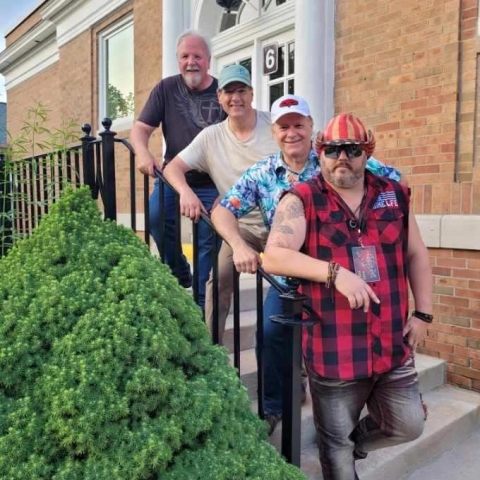 The band members of American Ages on the steps of the 1927 Cromaine building entrance. 