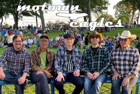 The Motown Eagles band, seated outdoors. 