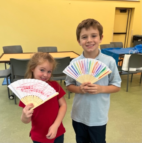 Passport Pals participants showing off their handmade fans. 