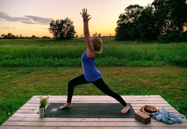 Debbie outdoors in a yoga pose