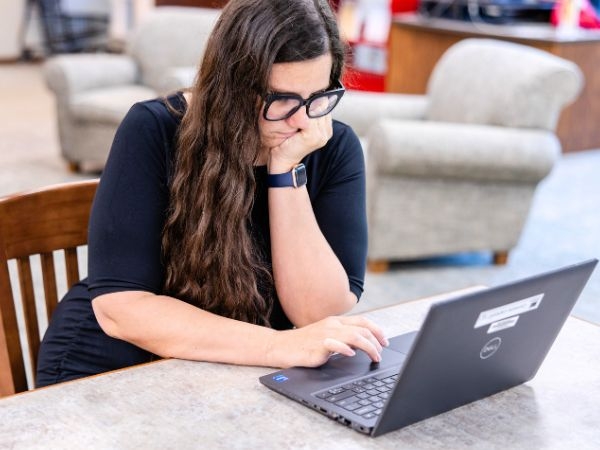 Librarian Rachel working on a laptop