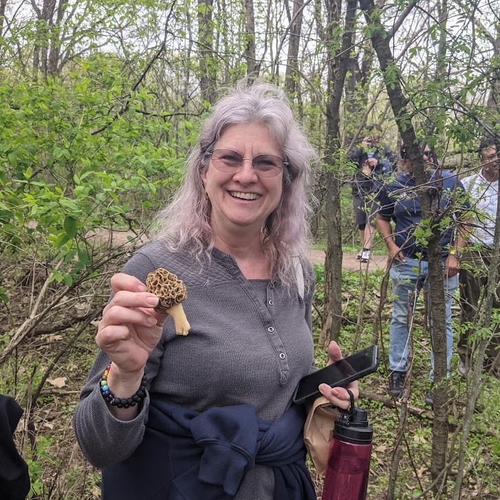 A very happy patron holding a morel mushroom. 