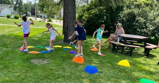 Children moving through an obstacle course on the South Lawn. 