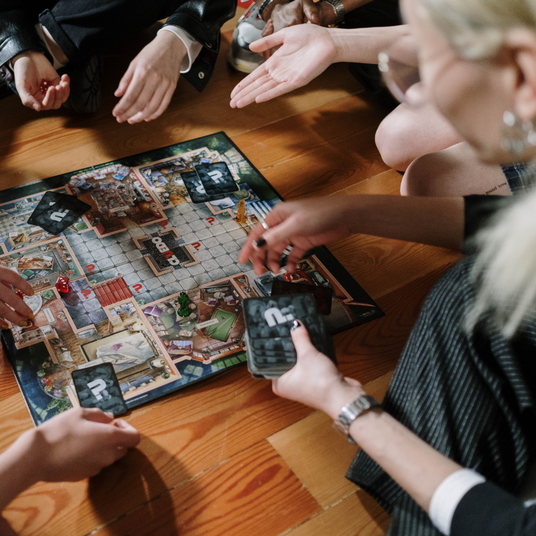 A group of people playing a board game. 