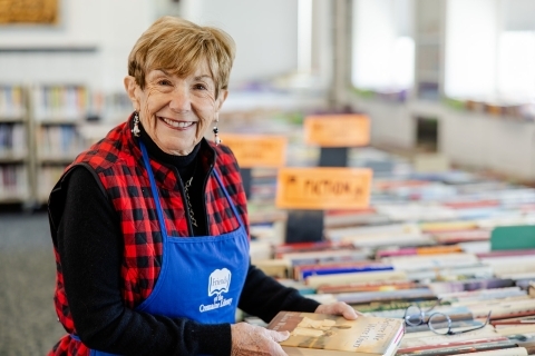 Mary Lynn in a Friends apron, filing books on the third floor in preparation for the Book Sale. 